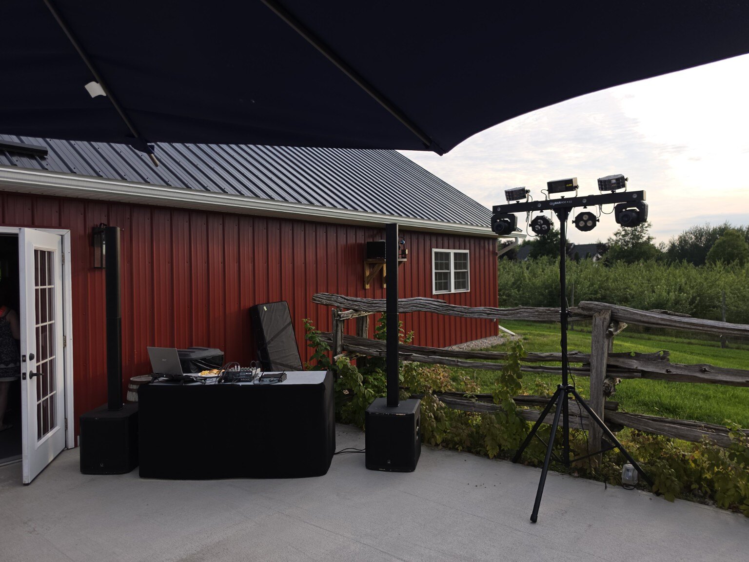 DJ setup outside a rustic red venue