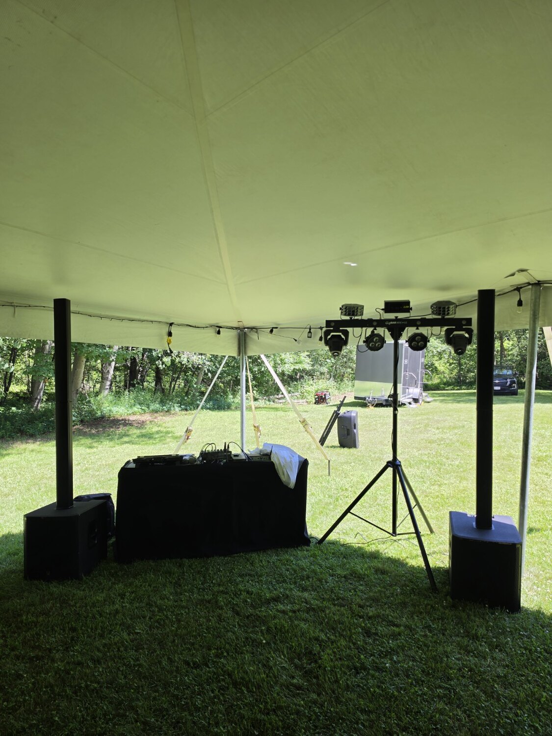DJ sound and lighting setup beneath a tent
