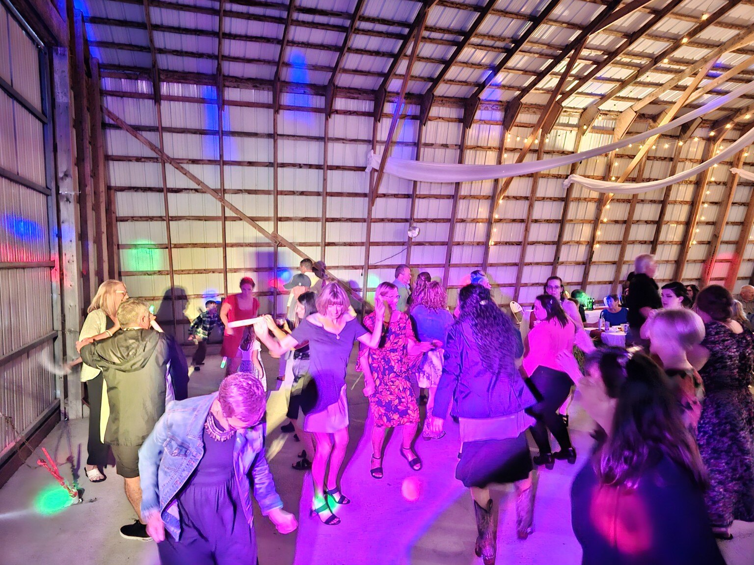 Reception crowd under colorful party lights