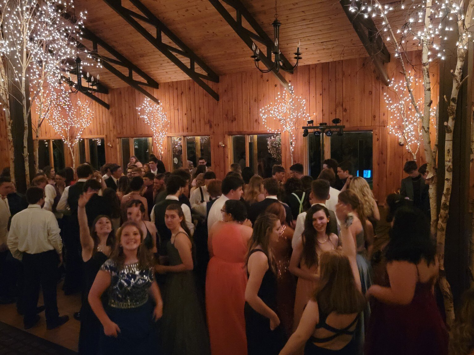 Guests dancing in a rustic barn venue