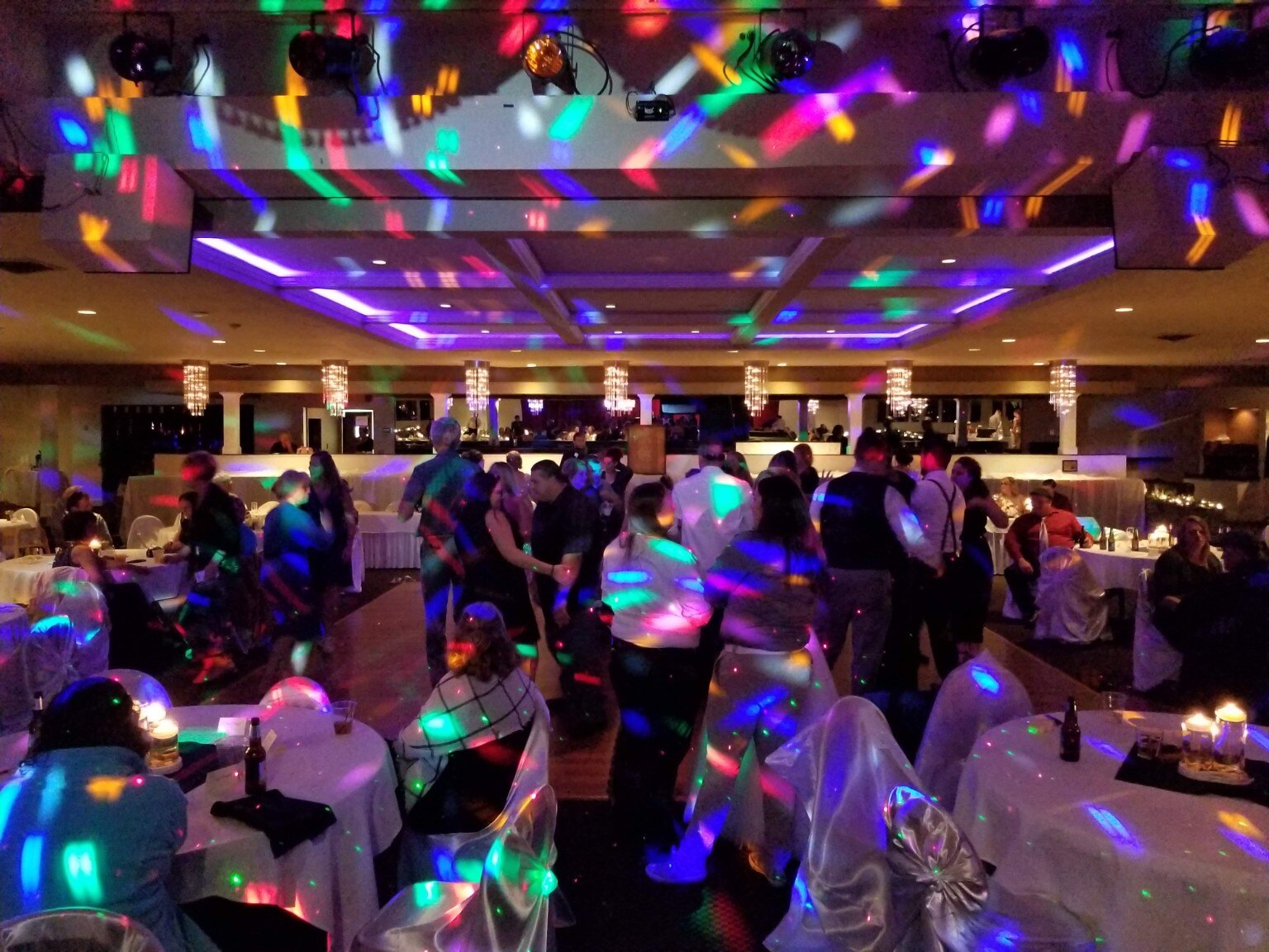Colorful lighting across a busy reception