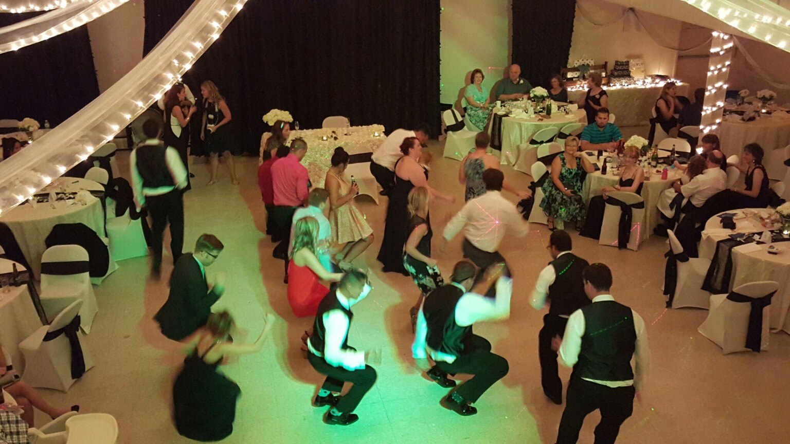 Wedding guests showing off a fun synchronized dance move