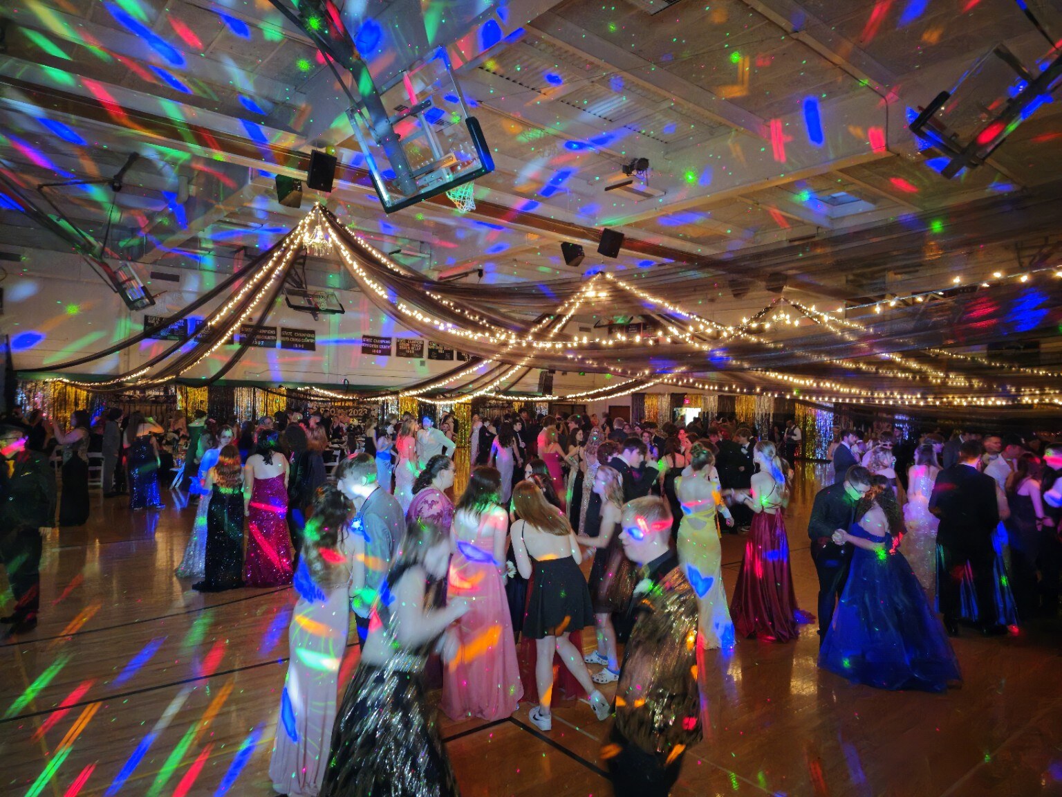 A packed celebration under colorful M-n-M Entertainment dance-floor lighting