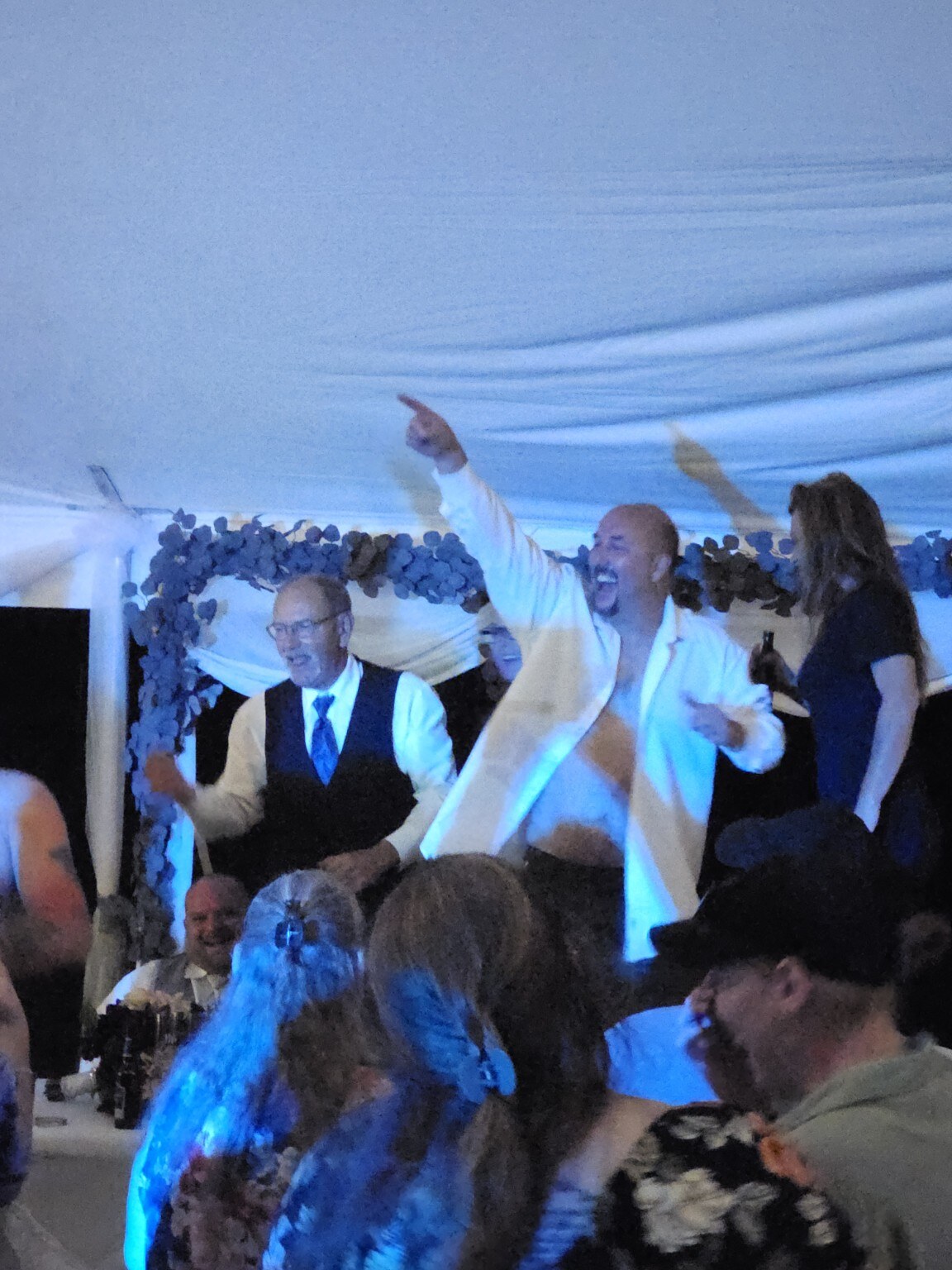 A guest celebrating enthusiastically on a crowded dance floor